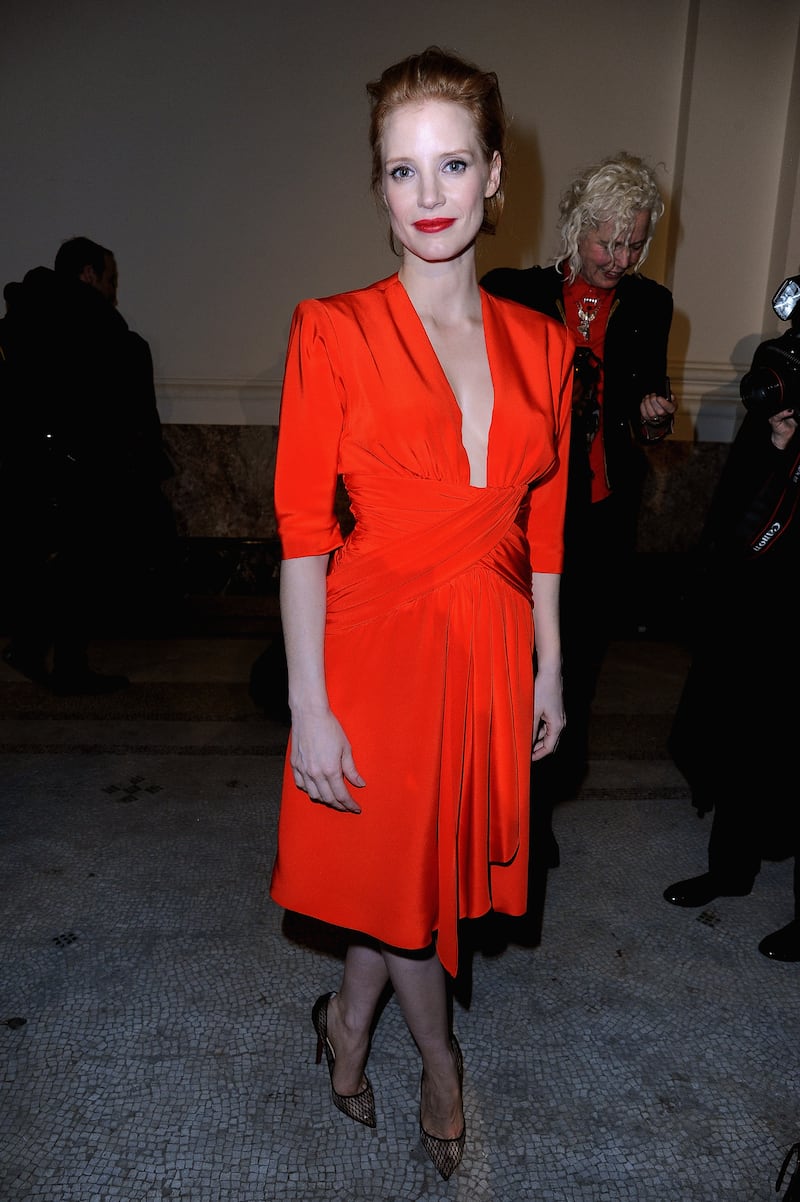 Jessica Chastain, in a red dress, attends the Saint Laurent autumn/winter 2013 show on March 4, 2013 in Paris. Getty Images