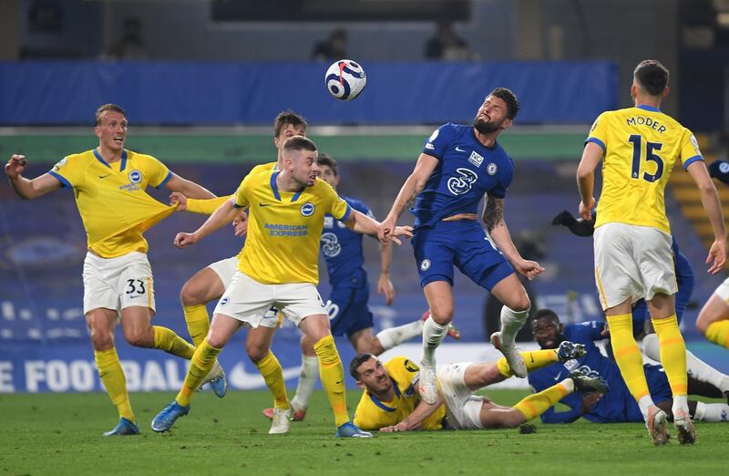 LONDON, ENGLAND - APRIL 20: Olivier Giroud of Chelsea and Adam Webster of Brighton & Hove Albion  battle for the ball  during the Premier League match between Chelsea and Brighton & Hove Albion at Stamford Bridge on April 20, 2021 in London, England. Sporting stadiums around the UK remain under strict restrictions due to the Coronavirus Pandemic as Government social distancing laws prohibit fans inside venues resulting in games being played behind closed doors.  (Photo by Mike Hewitt/Getty Images)