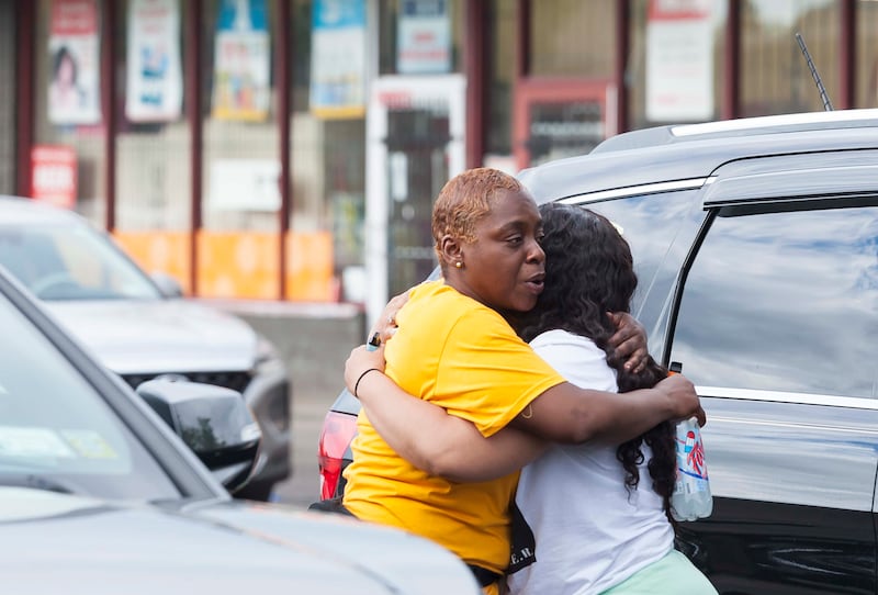 Two people hug near the scene of the mass shooting. EPA