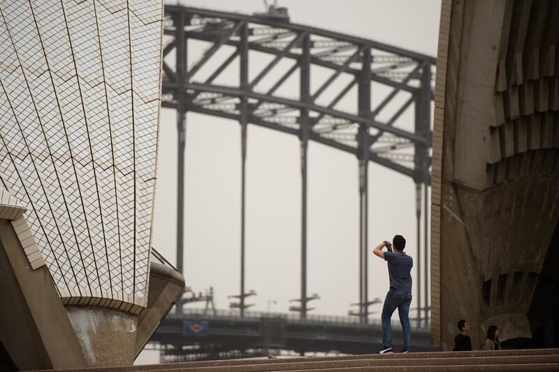 A man takes a photograph of the the Sydney Harbour Bridge from the Sydney Opera House. EPA