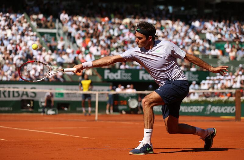 PARIS, FRANCE - JUNE 04:  Roger Federer of Switzerland plays a backhand in his Men's Singles quarter final match against Jo-Wilfried Tsonga of France during day ten of the French Open at Roland Garros on June 4, 2013 in Paris, France.  (Photo by Matthew Stockman/Getty Images) *** Local Caption ***  169913775.jpg