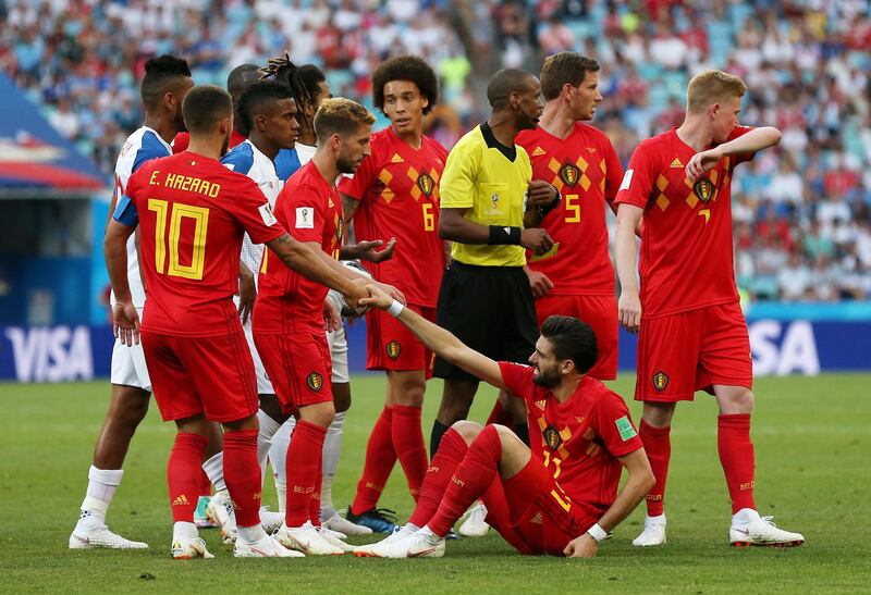 Eden Hazard helps teammate Yannick Carrasco to stand after he was fouled. Francois Nel / Getty Images