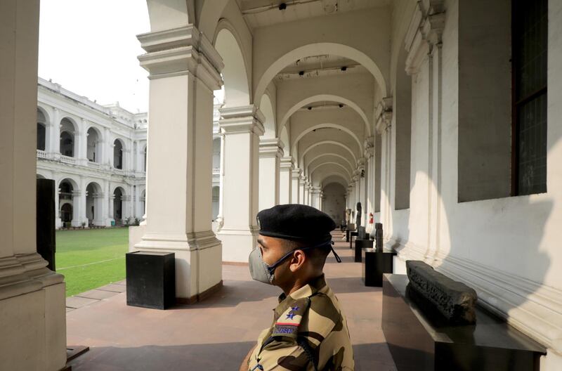 A security officer wears a protective mask as he stand guard at empty Indian Museum in Kolkata.  EPA