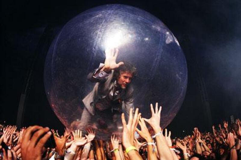Wayne Coyne is held aloft by the crowd inside an inflatable bubble at one of The Flaming Lips' performances.