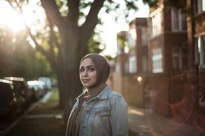 Abeer Najjar, a Palestinian American Muslim woman, poses for a portrait in front of her old home in Chicago's South Side Thursday, Sept. 21, 2017.
