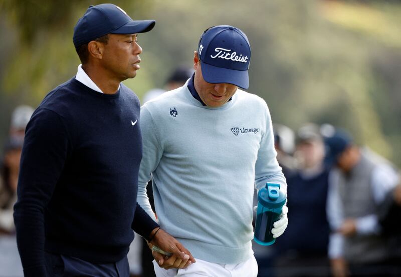 Tiger Woods is seen playing a prank on playing partner Justin Thomas by handing him a tampon during the first round of the PGA Genesis Invitational. The act has sparked controversy. AFP