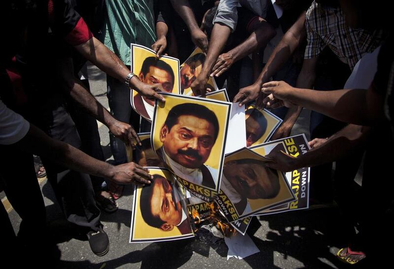 Supporters of Marumalarchi Dravida Munnetra Kazhagam burn portraits of Sri Lankan President Mahinda Rajapaksa during a protest in New Delhi, India. Tsering Topgyal / AP Photo