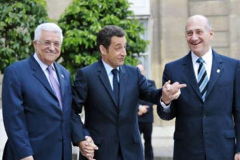 The French president Nicolas Sarkozy (centre) welcomes the Palestinian Authority president Mahmoud Abbas (left) and the Israeli prime minister Ehud Olmert (right) at the Elysee palace.
