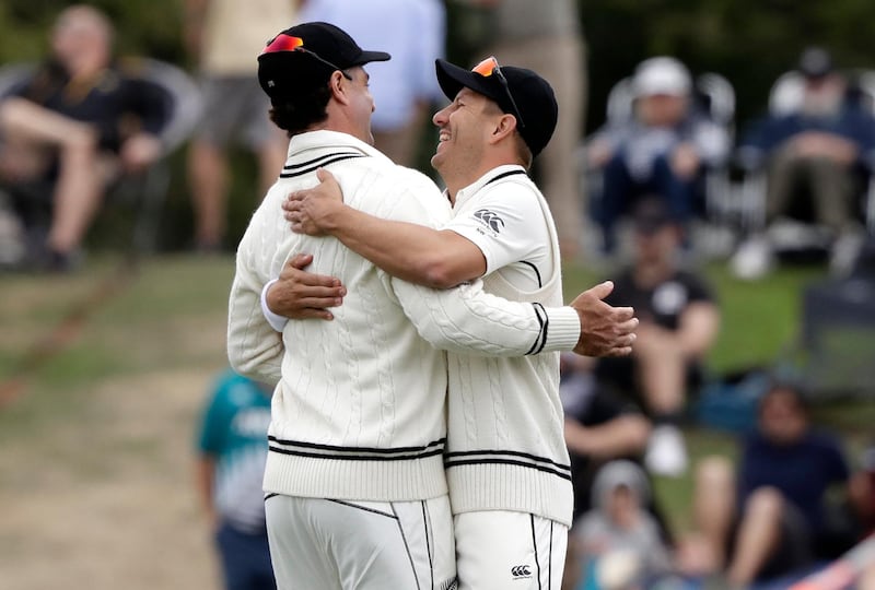 New Zealand's Neil Wagner, right, and Colin de Grandhomme celebrate after dismissing India for 124 runs in their second innings on Monday. AP