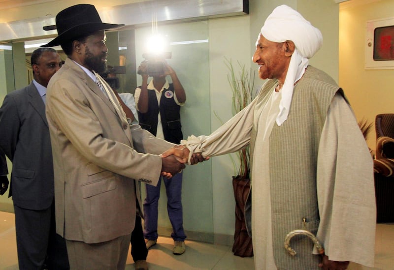 First Vice President Salva Kiir welcomes leader of the opposition Umma Party and former prime minister Sadiq Al Mahdi in July 2010. Reuters