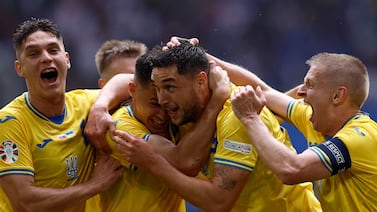 Ukraine's forward #09 Roman Yaremchuk (2nd R) celebrates scoring his team's second goal with his teammates during the UEFA Euro 2024 Group E football match between Slovakia and Ukraine at the Duesseldorf Arena in Duesseldorf on June 21, 2024.  (Photo by KENZO TRIBOUILLARD  /  AFP)