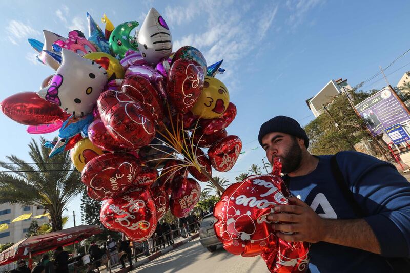 A Palestinian man sells ballons ahead of New Year's celebrations in Gaza City.  AFP
