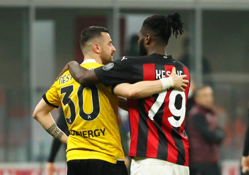 AC Milan's Franck Kessie with Udinese's Ilija Nestorovski after the match. Reuters