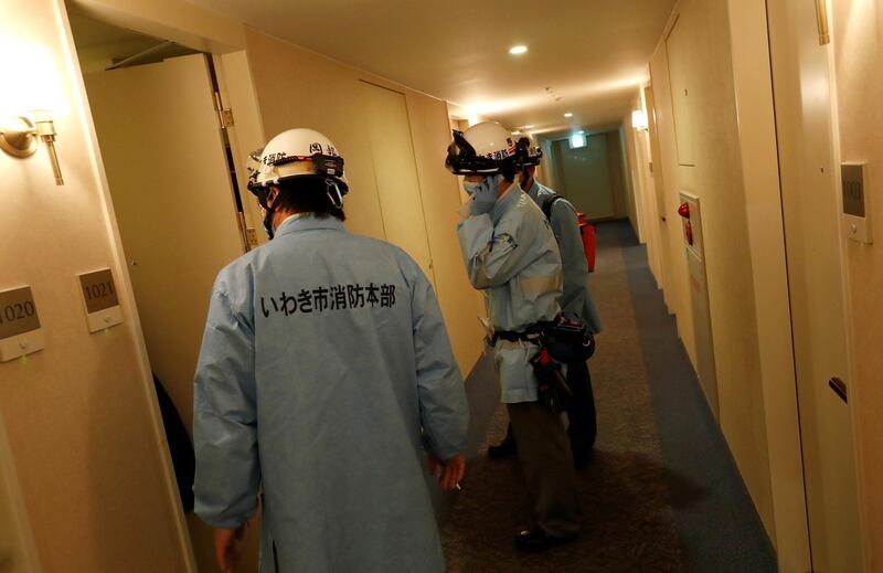 Ambulance crew members stand in the hotel corridor following a strong earthquake in Iwaki, Fukushima prefecture, Japan February 13, 2021. REUTERS