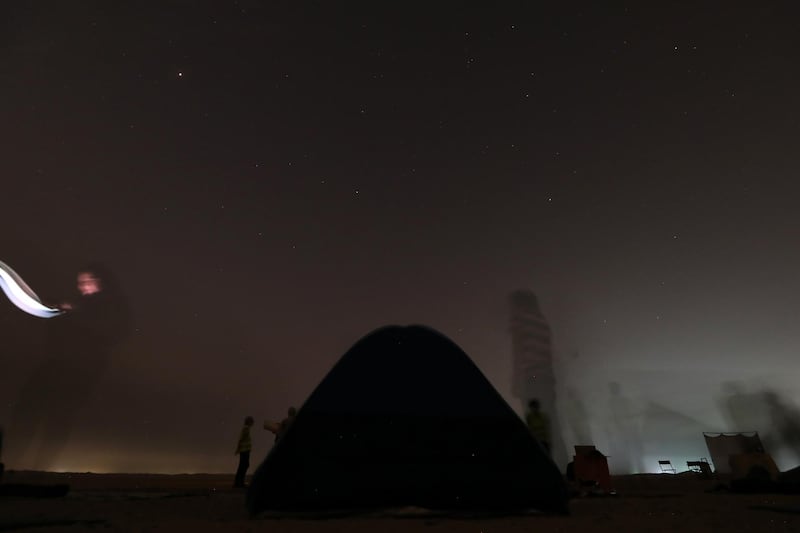 DUBAI, UNITED ARAB EMIRATES , August 13 – 2020 :- People watching the Perseid meteor shower at the Al Qudra desert area in Dubai. The event was organized by Dubai Astronomy Group with all the precaution against Covid 19 such as safe distance between the families and mask was mandatory. The event started on August 12 at 10pm to 2am on August 13.  (Pawan Singh / The National) For News/Standalone/Online/Instagram/Big Picture