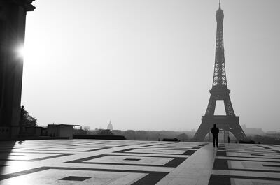 PARIS, FRANCE - MARCH 28: EDITORS NOTE : (This image has been converted to Black and White). A police officer walks on Trocadero square with the Eiffel tower in the background on March 28, 2020 in Paris, France. The country has introduced fines for people caught violating its nationwide lockdown measures intended to stop the spread of COVID-19. The pandemic has spread to at least 182 countries, claiming over 30,000 lives and infecting hundreds of thousands more. (Photo by Pascal Le Segretain/Getty Images)