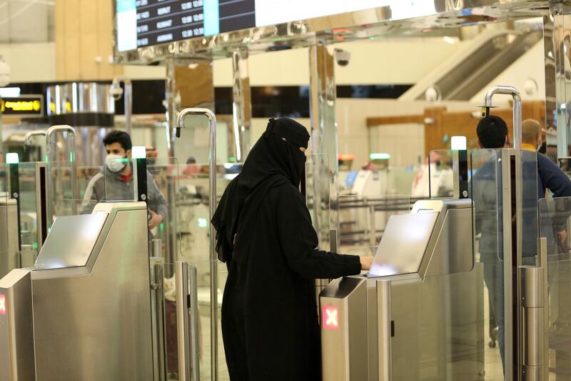 A Saudi woman scans her documents at the digital immigration gate at the King Khalid International Airport in Riyadh. Reuters