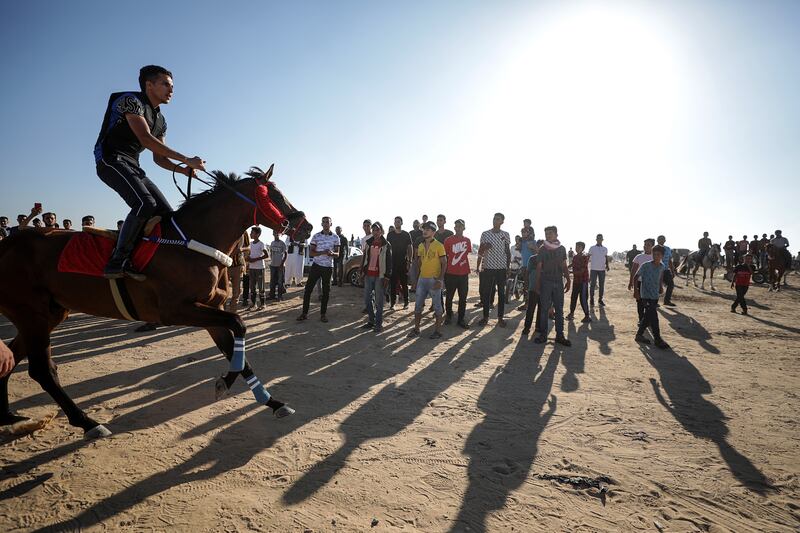 A Palestinian rides a horse during a race on the airfield of Yasser Arafat International Airport in Rafah, Gaza. All photos: EPA