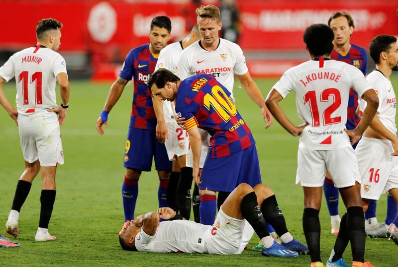 Lionel Messi stands over Sevilla's Diego Carlos. Reuters