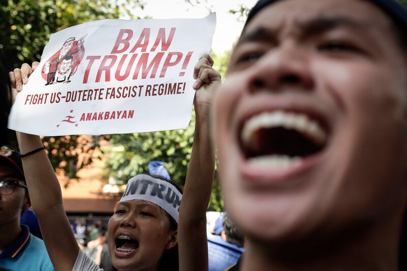 epa06323885 Activists shout slogans while holding placards with the images of US President Donald J. Trump and Philippine President Rodrigo Duterte during a protest near the US embassy in Manila, Philippines, 12 November 2017. The Philippines is hosting the 31st Association of Southeast Asian Nations (ASEAN) Summit and Related Meetings from 10 to 14 November.  EPA/MARK R. CRISTINO