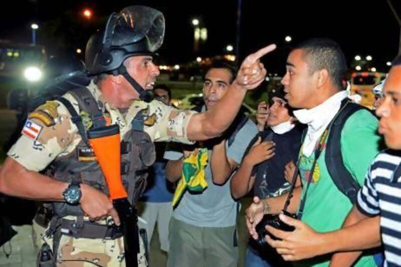 Riot police argue with demonstrators during a protest in Salvador.