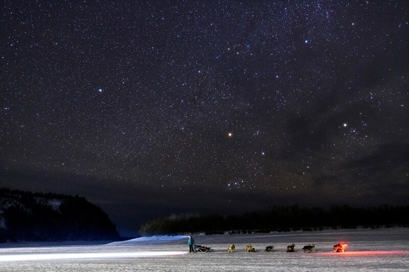 Kristy Berington waits on the Innoko River for her sister, Anna Berington, after they both left Shageluk, Alaska, during the Iditarod Trail Sled Dog Race. AP Photo