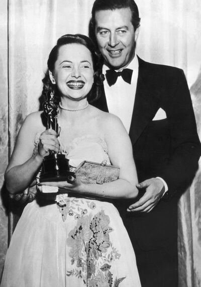 Actress Olivia de Havilland Dies at 104 who appeared in Gone With The Wind announced in July 26,2020. 19th March 1947:  Olivia de Havilland receives her Best Actress Oscar from actor Ray Milland (1907 - 1986)  for her performance in 'To Each his Own', directed by Mitchell Leisen.  (Photo by Keystone/Getty Images)