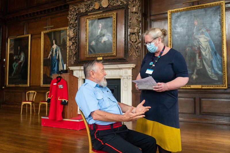 Chelsea Pensioner John Byrne talks to Deputy Chief Nurse Vanessa Sloane before receiving a Covid-19 vaccination at the Royal Hospital Chelsea, a retirement home for former soldiers, in London. PA