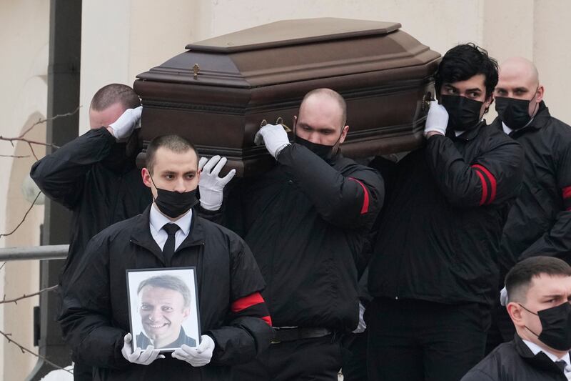 A portrait of Kremlin critic Alexei Navalny is carried before his coffin from the Church of the Icon of the Mother of God Soothe My Sorrows, in Moscow. AP