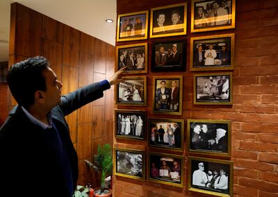 Moti Mahal Delux Managing Director Monish Gujral shows photographs of celebrities and politicians visiting the restaurant chain's original outlet in New Delhi. Reuters