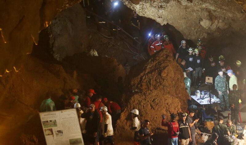 Emergency rescue teams gather in the staging area as they continue the search for 12 young footballers and their coach after going missing in a large cave in Mae Sai, Chiang Rai province, in northern Thailand. Sakchai Lalit / AP Photo