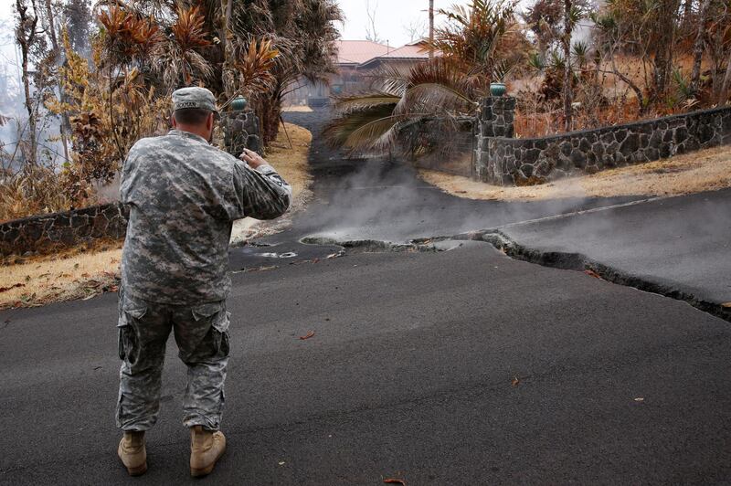 Major Jeff Hickman, of the Hawaii National Guard, takes a photo in the Leilani Estates subdivision during ongoing eruptions of the Kilauea Volcano in Hawaii on  May 13, 2018. Terray Sylvester / Reuters