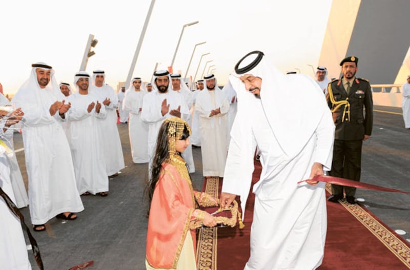 The late president Sheikh Khalifa returns a pair of scissors he used to cut the ceremonial ribbon symbolising the formal opening of the Sheikh Zayed Bridge in Abu Dhabi, on November 28, 2010. Photo: Wam