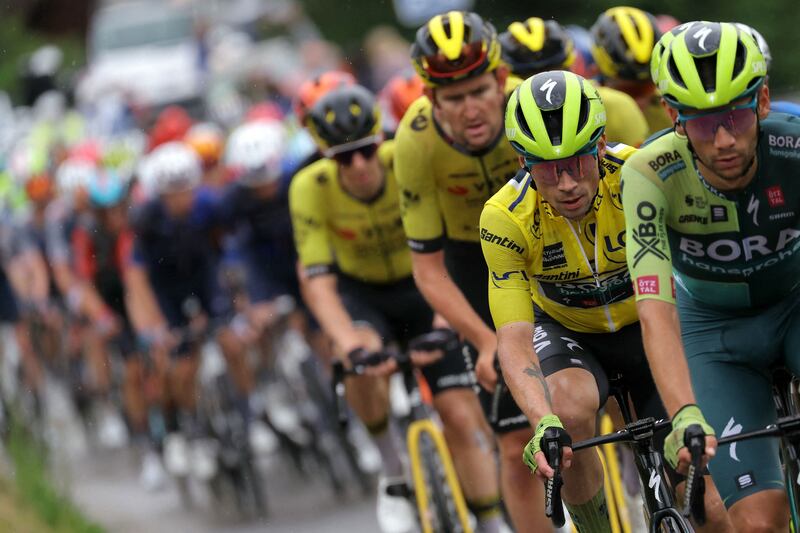 Team Bora's Slovenian rider Primoz Roglic in the overall leader's yellow jersey cycles with the pack during the seventh stage of the 76th edition of the Criterium du Dauphine race in the French Alps. AFP