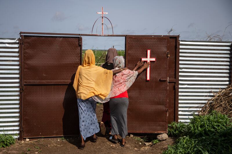 Women leave a Catholic church after prayers at Shagarab camp. Getty