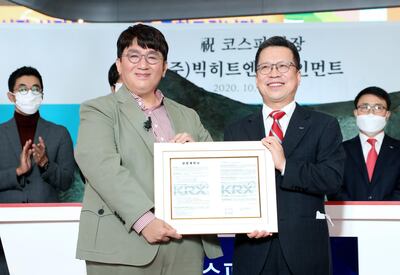 SEOUL, SOUTH KOREA - OCTOBER 15: In this handout image provided by Korea Exchange (KRX), Bang Si-hyuk (L) founder of Big Hit Entertainment Co., and other attendee at the company's initial public offering ceremony at the Korea Exchange (KRX) on October 15, 2020 in Seoul, South Korea. Big Hit Entertainment, the management agency of K-pop superstar BTS, began livestreaming its market debut on South Korea's main bourse Thursday. The Seoul-based entertainment company was listed on the main KOSPI and began trading at 9 a.m., the Korea Exchange said. (Photo by Korea Exchange via Getty Images)