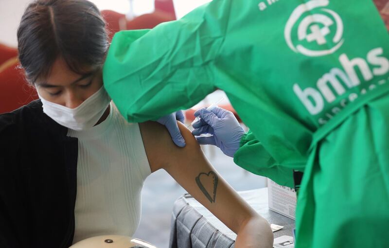 A woman receives a dose of AstraZeneca vaccine during a Covid-19 vaccination drive at a shopping mall in Jakarta, Indonesia. EPA