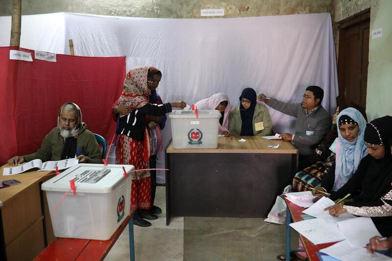 A woman puts her ballot paper into the ballot box in Dhaka. Reuters