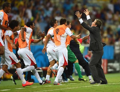 FORTALEZA, BRAZIL - JUNE 14:  Costa Rica players celebrate with head coach Jorge Luis Pinto after their teams third goal  during the 2014 FIFA World Cup Brazil Group D match between Uruguay and Costa Rica  at Castelao on June 14, 2014 in Fortaleza, Brazil.  (Photo by Laurence Griffiths/Getty Images)