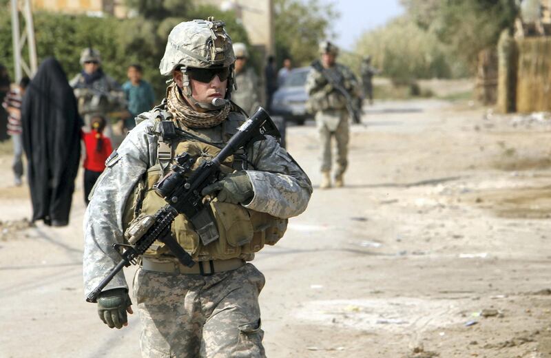 A US soldier stands guard near a school in the town of Iskandiriyah in Iraq's Babel province, 45 kms south of Baghdad, where American troops were donating on 27 October, 2011 books and gifts for local students. US President Barack Obama announced last week that all US troops will leave Iraq by the end of the year, ending a long war which cleaved deep political divides and estranged the United States from its allies.
AFP PHOTO / ALI AL SAADI (Photo by ALI AL-SAADI / AFP)
