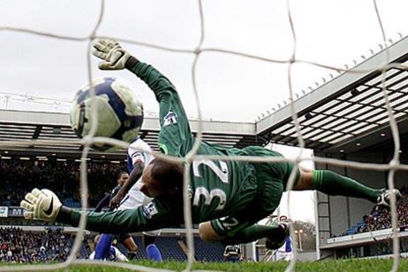 Didier Drogba, back left, scores Chelsea's goal past the dive of Blackburn's Jason Brown.