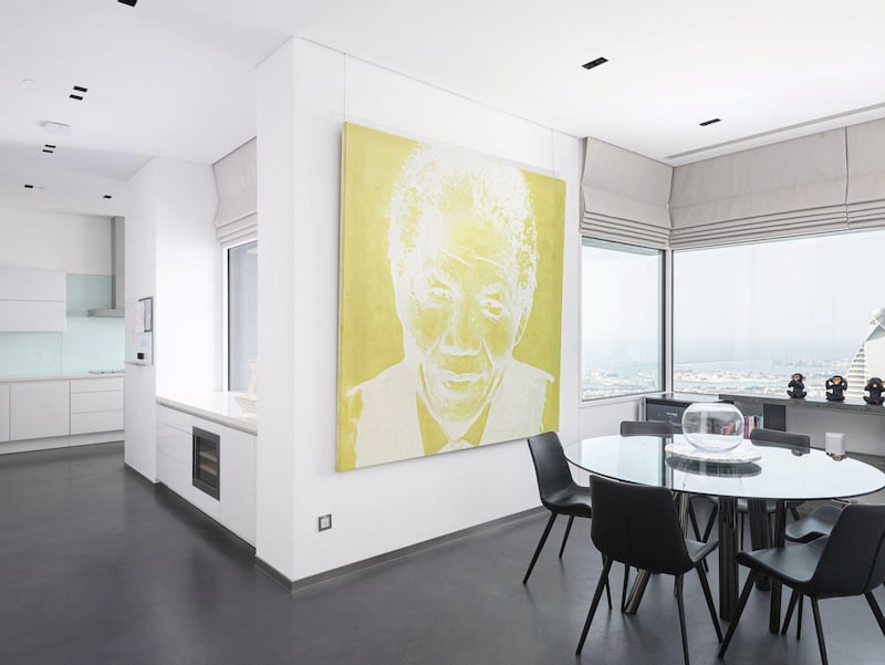A statement green Nelson Mandela painting overlooking the informal dining area. Courtesy Luxhabitat Sotheby's International Realty