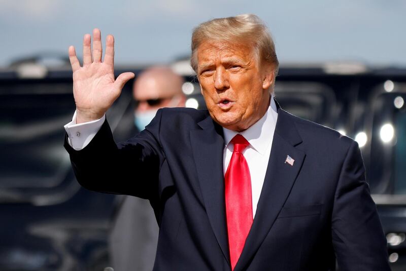 FILE PHOTO: U.S. President Donald Trump waves as he arrives at Palm Beach International Airport in West Palm Beach, Florida, U.S., January 20, 2021. REUTERS/Carlos Barria/File Photo/File Photo