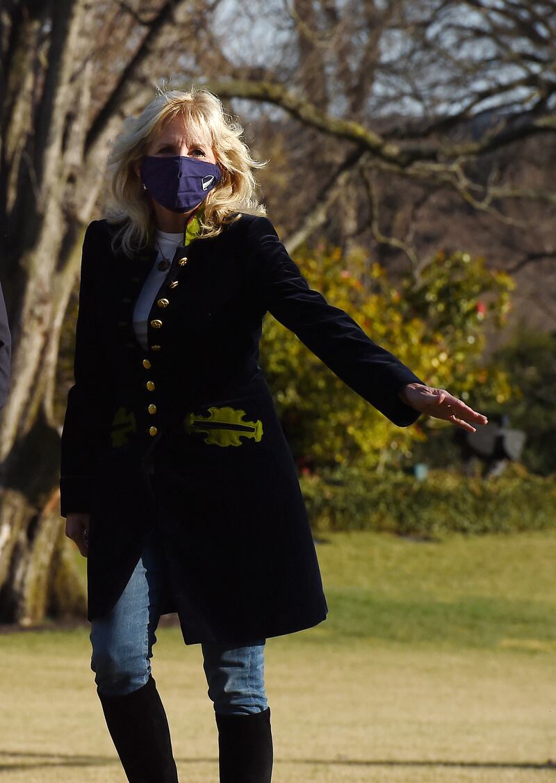 Jill Biden, wearing a military-style coat, walks across the South Lawn to the White House on March 21, 2021. AFP