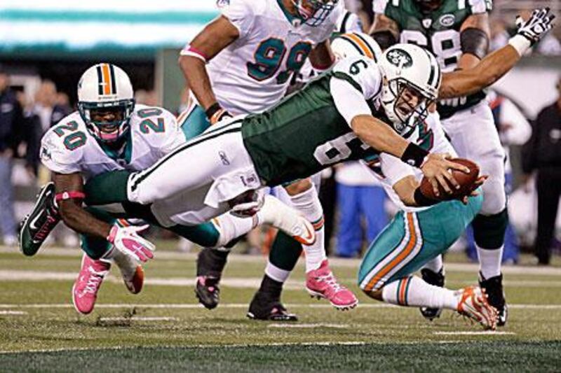 Mark Sanchez, the New York Jets quarterback, dives for a touchdown in his side's 24-6 win against the Miami Dolphins.