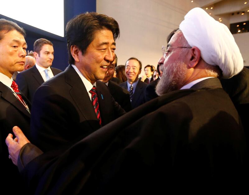 FILE PHOTO: Japan's Prime Minister Shinzo Abe greets Iran's President Hassan Rouhani (R) during the annual meeting of the World Economic Forum (WEF) in Davos January 22, 2014.  REUTERS/Denis Balibouse/File Photo