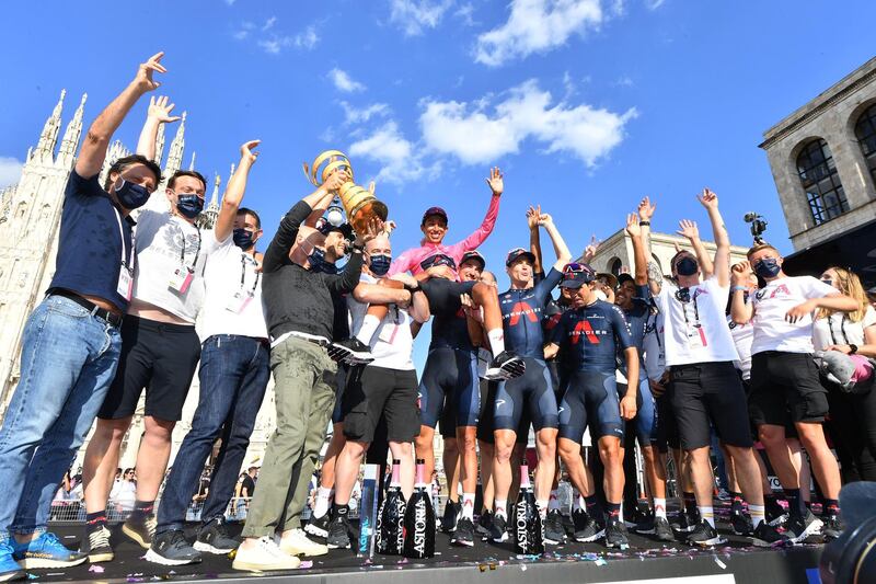 Ineos Grenadiers rider Egan Bernal poses with the trophy and teammates. Reuters