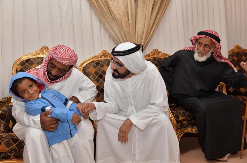 Sheikh Mohammed bin Rashid in the Shahidi home Saif Al Zaabi and Abdullah Hamoudi. Photo: WAM