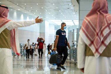 A traveller, wearing a mask due to the Covid-19 coronavirus pandemic, walking with his luggage as part of the first group of arrivals for the annual Hajj pilgrimage, at the Red Sea coastal city of Jeddah's King Abdulaziz International Airport. AFP