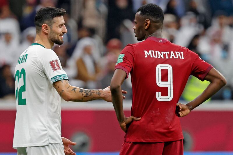 Iraq defender Rebin Sulaka and Qatar forward Mohammed Muntari during the Arab Cup 2021 Group A match in Al Khor.